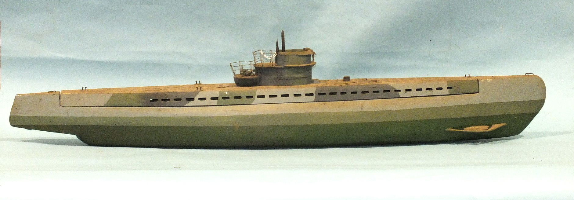 A scratch-built wood model of a submarine, the deck lifts to reveal a motor compartment with drive