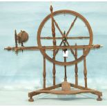 A 19th century spinning wheel of small size, on triangular base, 62cm to top of wheel.