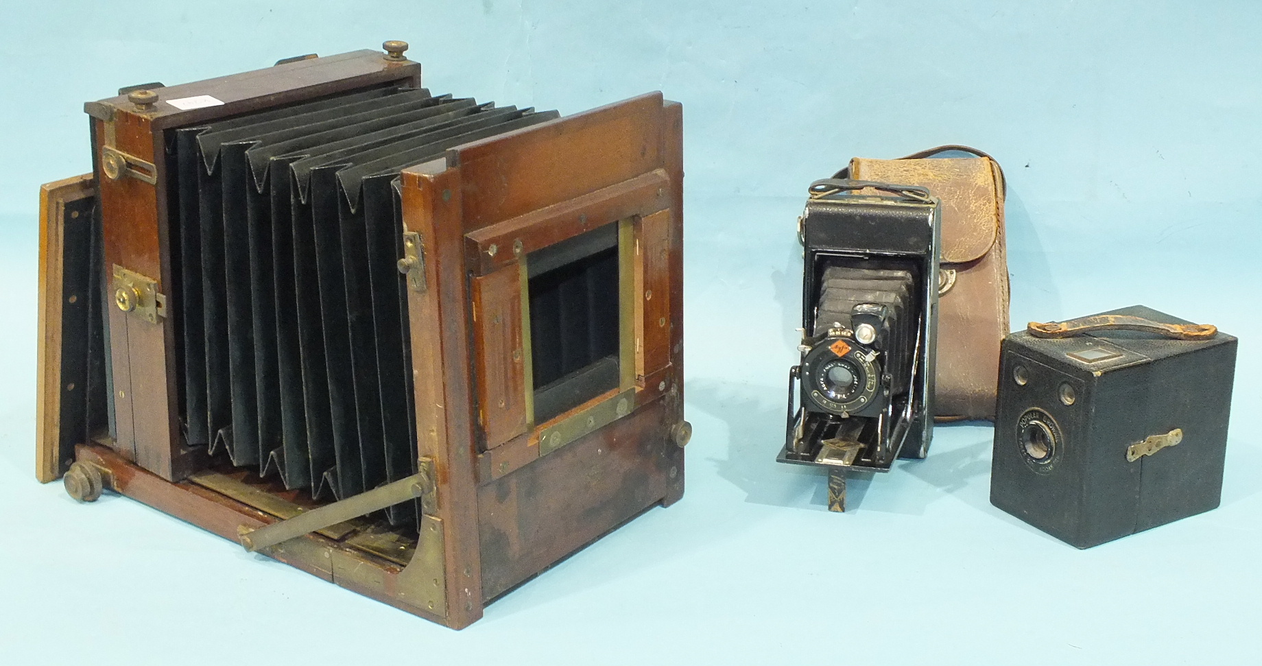 A 19th century full-plate studio camera, (no lens), an Agfa folding camera and a Box Brownie, (3).