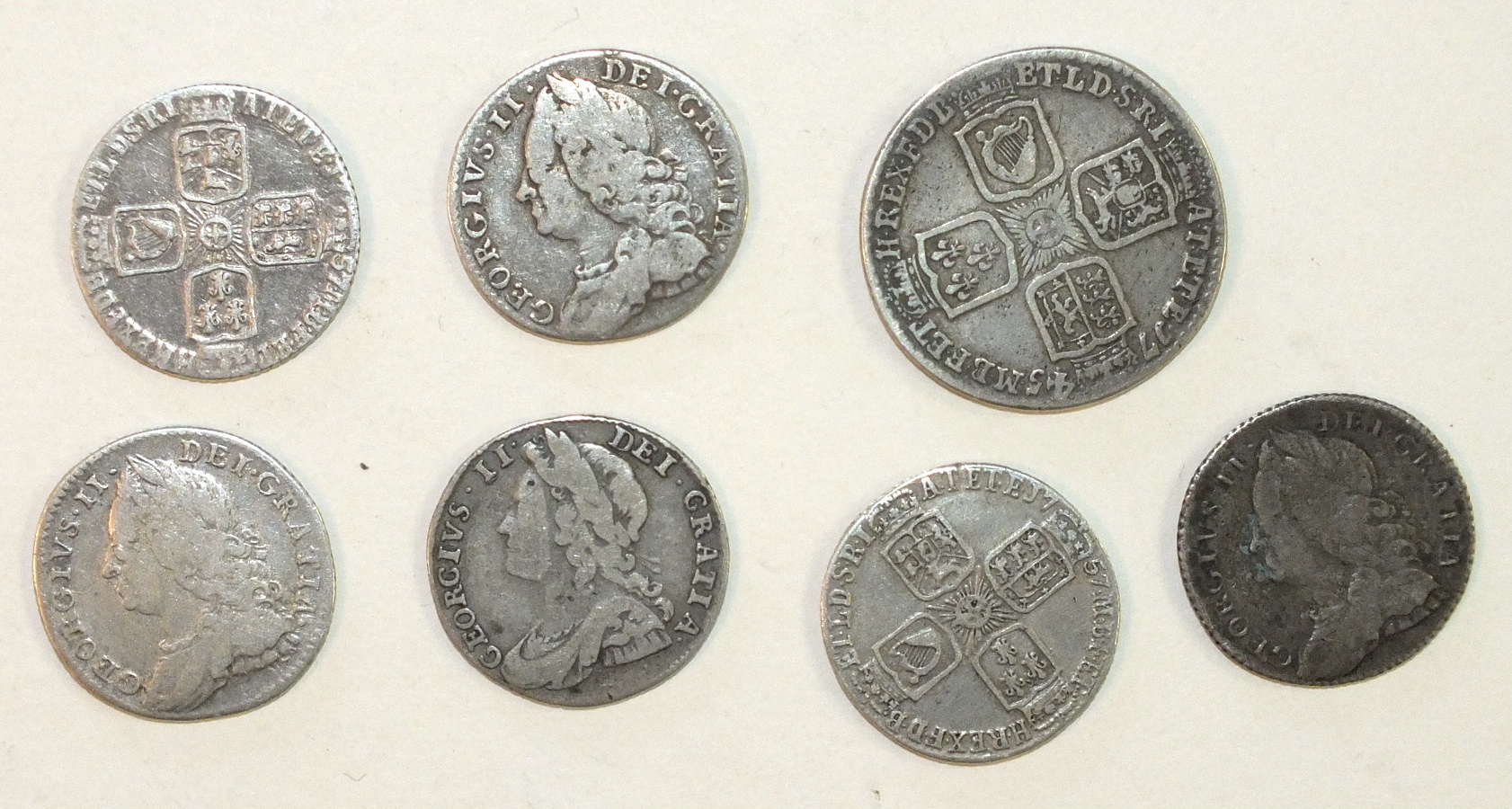 A George II shilling 1745 (Lima), sixpence 1732, 1757 (x4), 1758, (7).