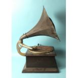 A grained-wood-cased table-top gramophone with pressed tin horn, base 39 x 39cm, horn 46cm