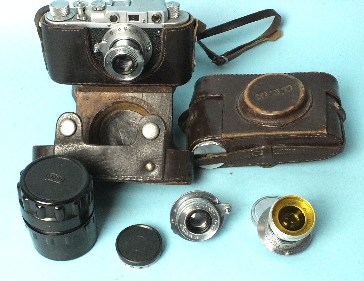 A Russian Fed copy of a Leica II Rangefinder camera, numbered 669086, in leather case, a Fed leather