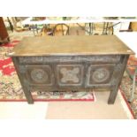 An oak low sideboard, the rectangular top above a pair of carved panel doors, 120cm wide.