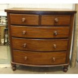 A late-19th century mahogany bow-fronted chest of two short and three long drawers, on turned