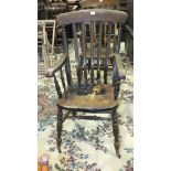 A stained beech and elm lathe-back farmhouse-style chair on turned legs.