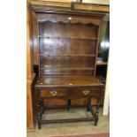 A reproduction small oak dresser in the 18th century style, the plate rack above two small