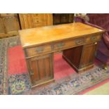 A late-19th/early-20th century mahogany knee-hole desk, the rectangular top fitted with three frieze