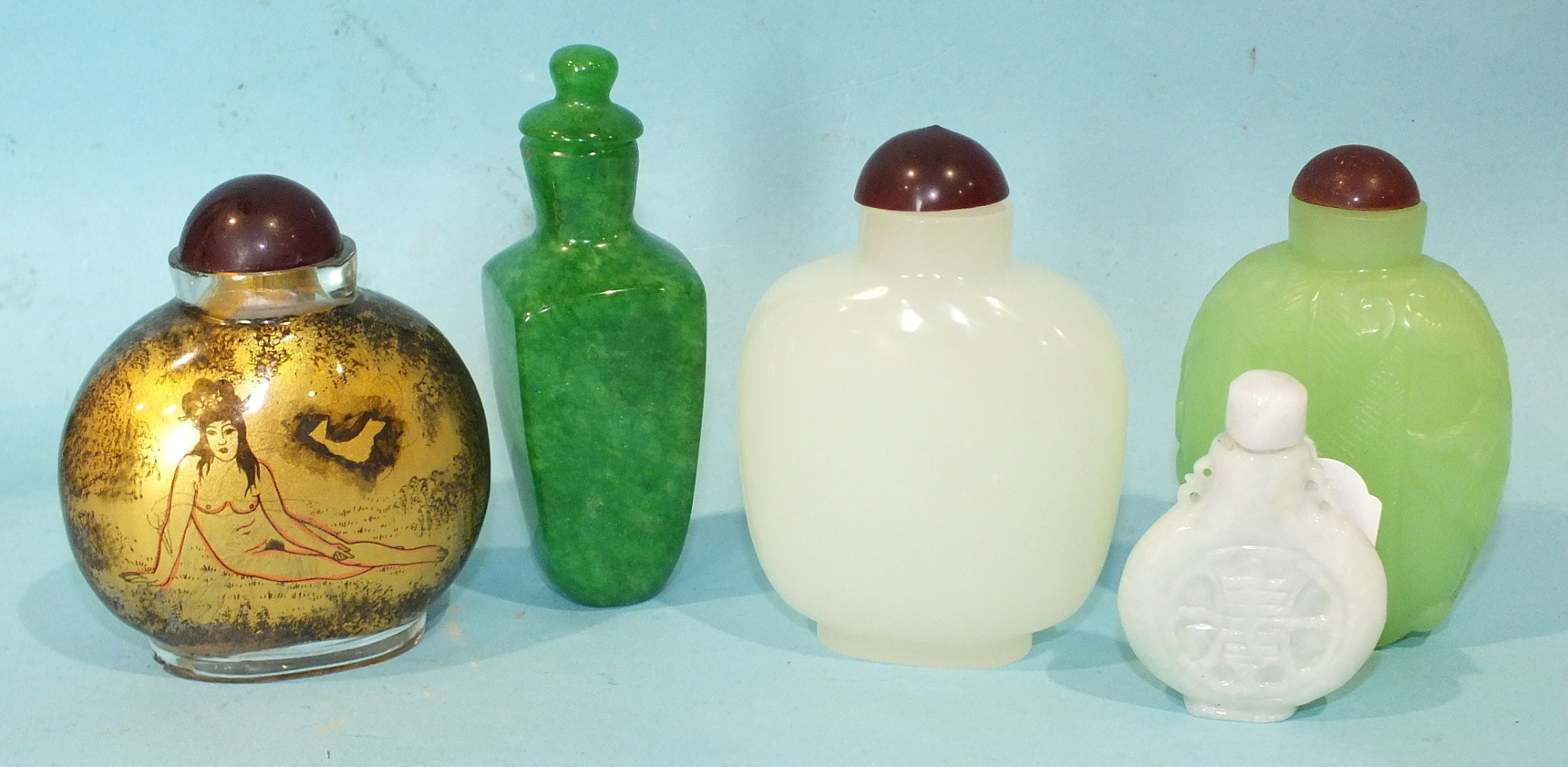 Five Oriental glass snuff bottles in imitation of jade and other hardstones, one with gilt erotic