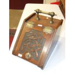 An Edwardian coal box with brass handle and hinged sloping carved front, 32cm wide.