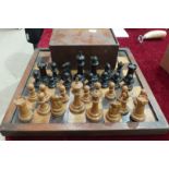 A Staunton style boxwood and ebonised chess set in a hardwood box and a chess board, king 10cm,