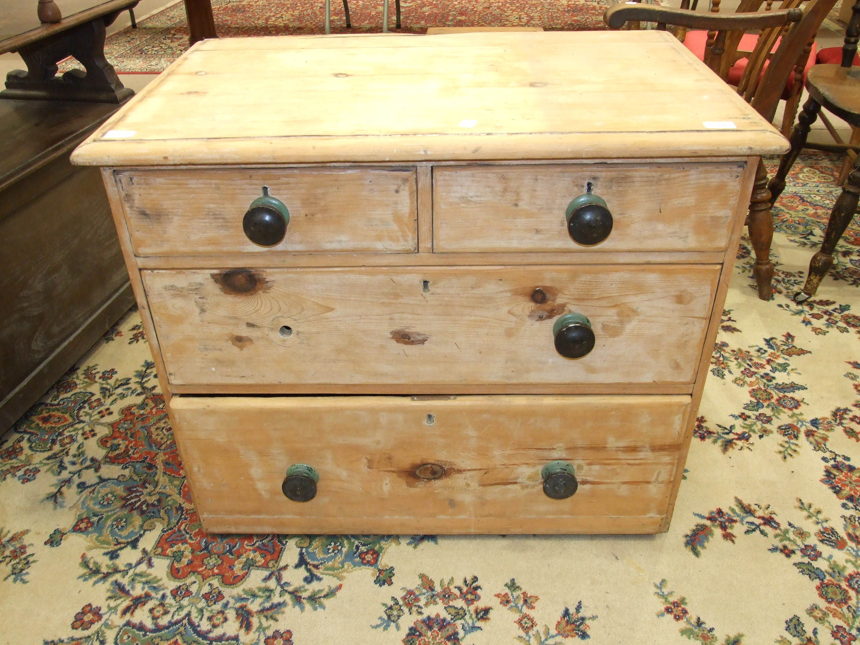 A stripped pine straight-front chest of two short and two long drawers, 91cm wide, (legs lacking).