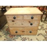 A stripped pine straight-front chest of two short and two long drawers, 91cm wide, (legs lacking).