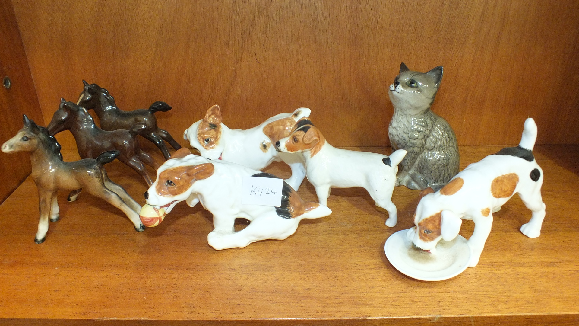 A Royal Doulton model of a dog licking a plate, two other Royal Doulton dog models and five