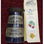 A Cadbury's Dairy Milk Chocolate tinplate churn money box, 14.5cm high, (a/f) and a T Stevens silk