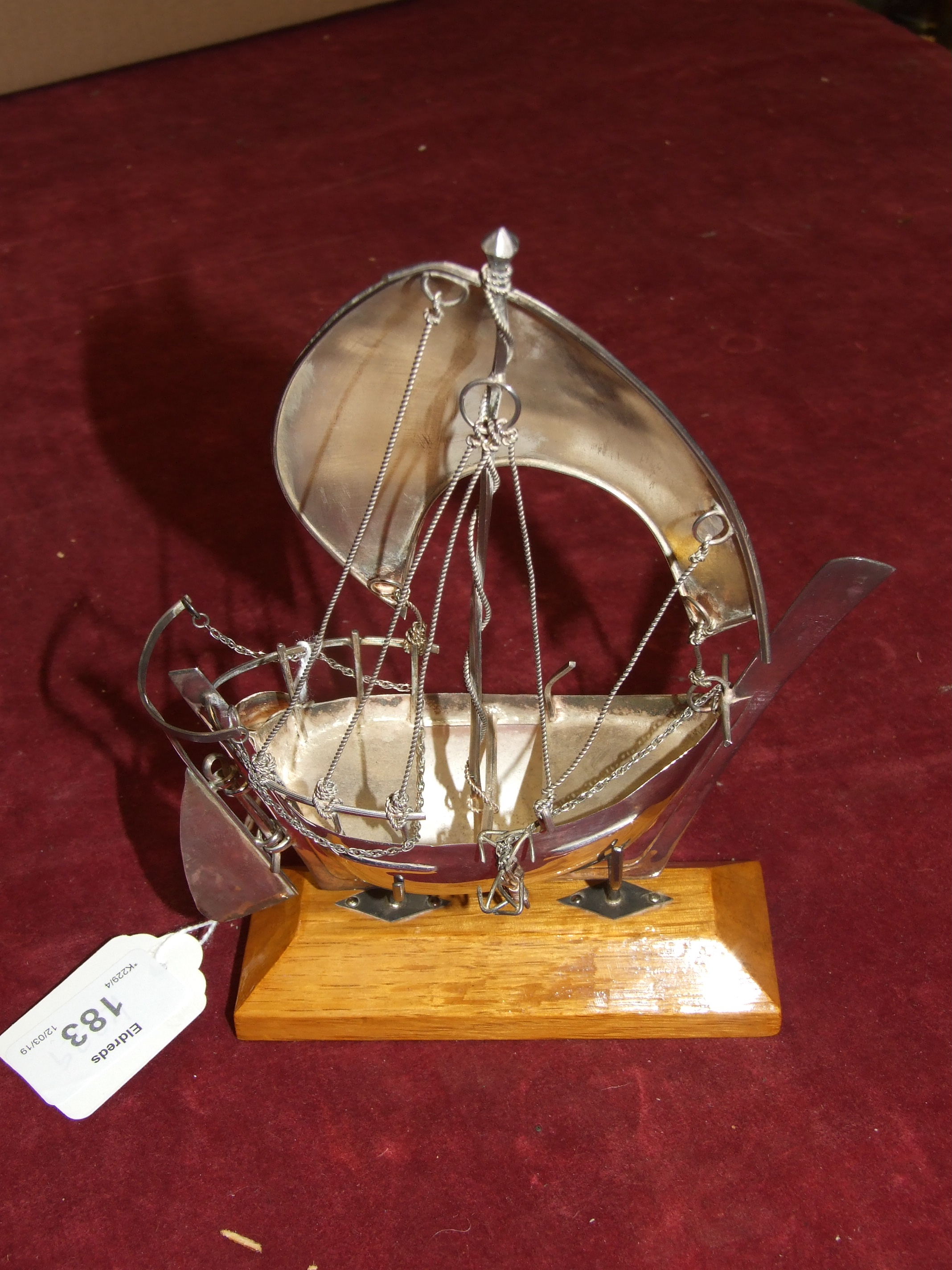 A white metal model of a dhow, on wood stand, 18cm high, in fitted box. - Image 2 of 2