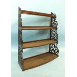 A mahogany four-tier hanging display shelf, each bowed shelf within pierced fret sides, 86cm high,