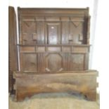 An antique Continental oak canopy bed of heavy panel oak construction, the back board, foot board