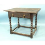 An antique oak side table, the rectangular top above a drawer, on bobbin-turned legs joined by