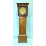 An 18th/19th century oak long case clock, the circular brass dial engraved with cabinet maker's tool