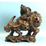 A Chinese carved wood figure of a man on a buffalo, 27cm high, (damaged).