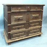 An antique oak chest in the 17th century style, having four harlequin drawers with applied