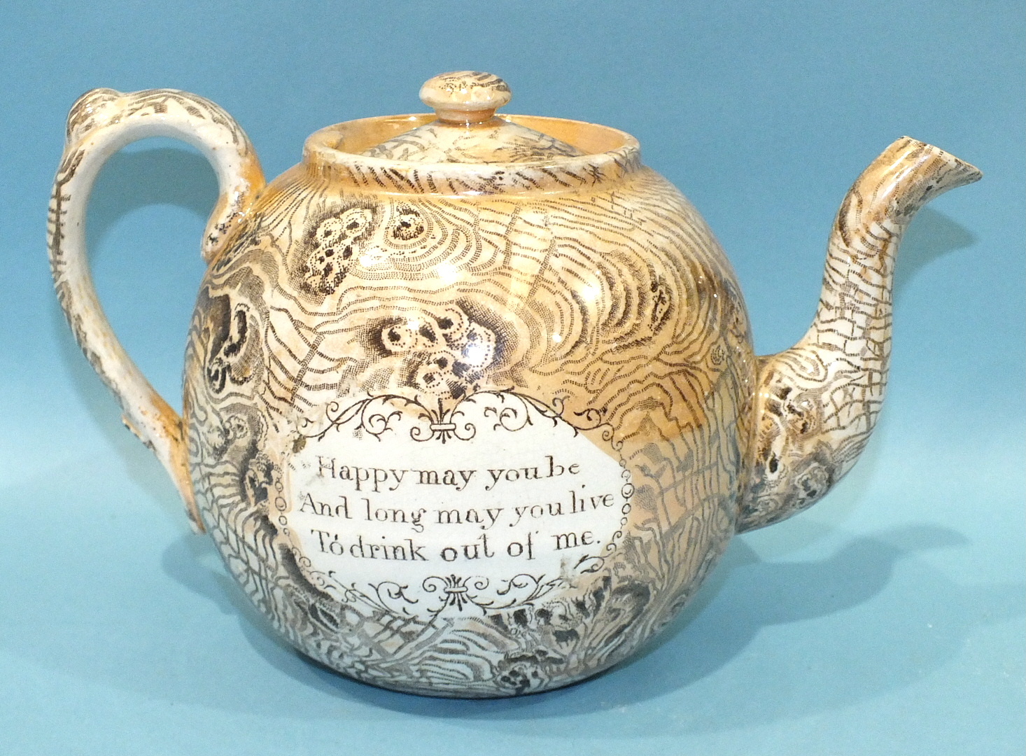 A late 19th century transfer-printed and lustre decorated tea pot of globe shape, the cartouche