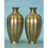 A pair of Chinese polished bronze fluted vases with archaic seal marks to base, 25cm high.