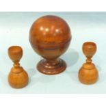 A 20th century polished boxwood pill roller of spherical form raised on a plinth, stamped S Maw &