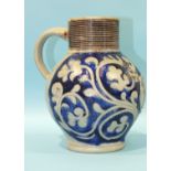An early-18th century Westerwald salt-glazed stoneware jug with stylised leaf decoration and a