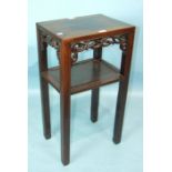 A 19th century Chinese hardwood plant stand, the rectangular panelled top with pierced apron above a