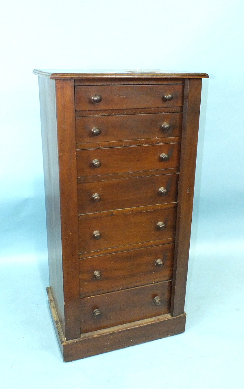 A Victorian walnut Wellington chest of seven drawers, on plinth base, 51cm wide, 106cm high.