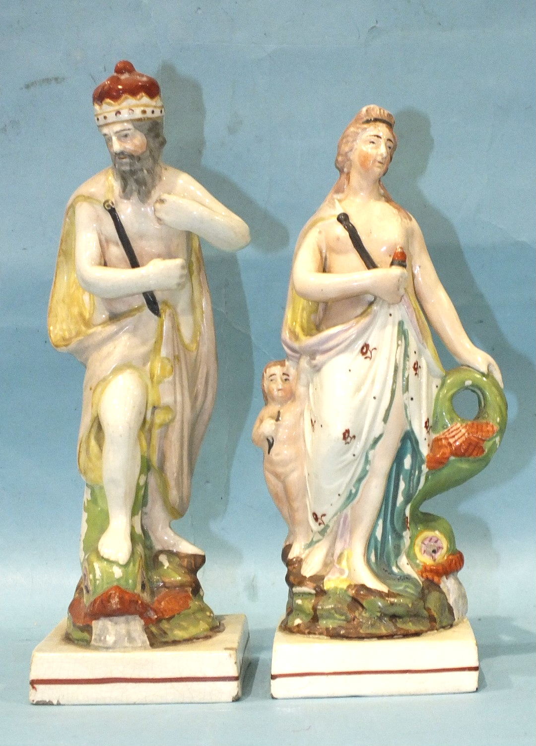 A pair of 19th century Staffordshire pearlware square-based figures of Neptune, 24cm high and