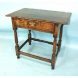 An 18th century oak side table, the rectangular top above a frieze drawer, on turned legs joined