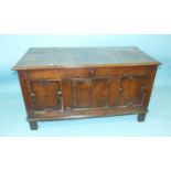 An antique oak panelled coffer, 123cm long, 65cm high.