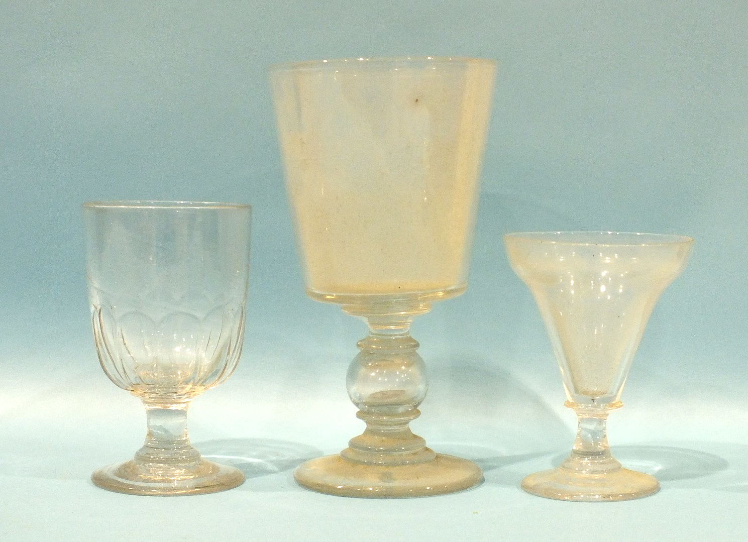 A large 19th century English glass bucket-shaped 'coin' goblet, 23cm, and two odd 19th century