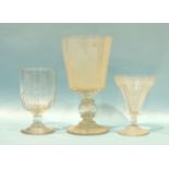 A large 19th century English glass bucket-shaped 'coin' goblet, 23cm, and two odd 19th century