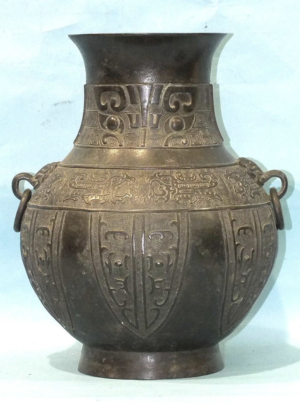 A large 19th century archaic-style Chinese bronze vase with applied ring handles and stylised animal