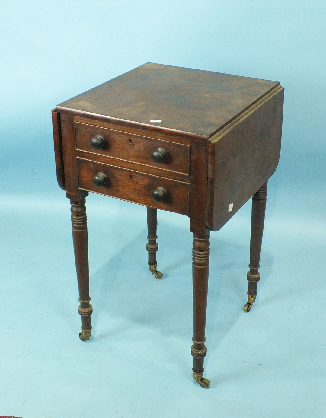 A George IV mahogany work table, the rectangular top with two drop leaves above two frieze and two