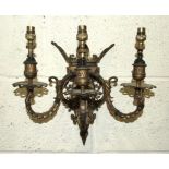 A pair of 19th century French gilt brass wall-mounted candelabra, each with three branches,