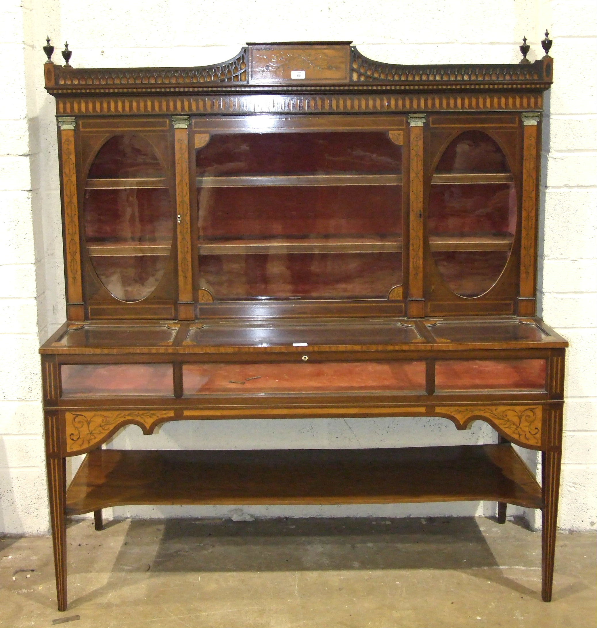 A 19th century mahogany and marquetry spinet case converted as a display cabinet, the fret work