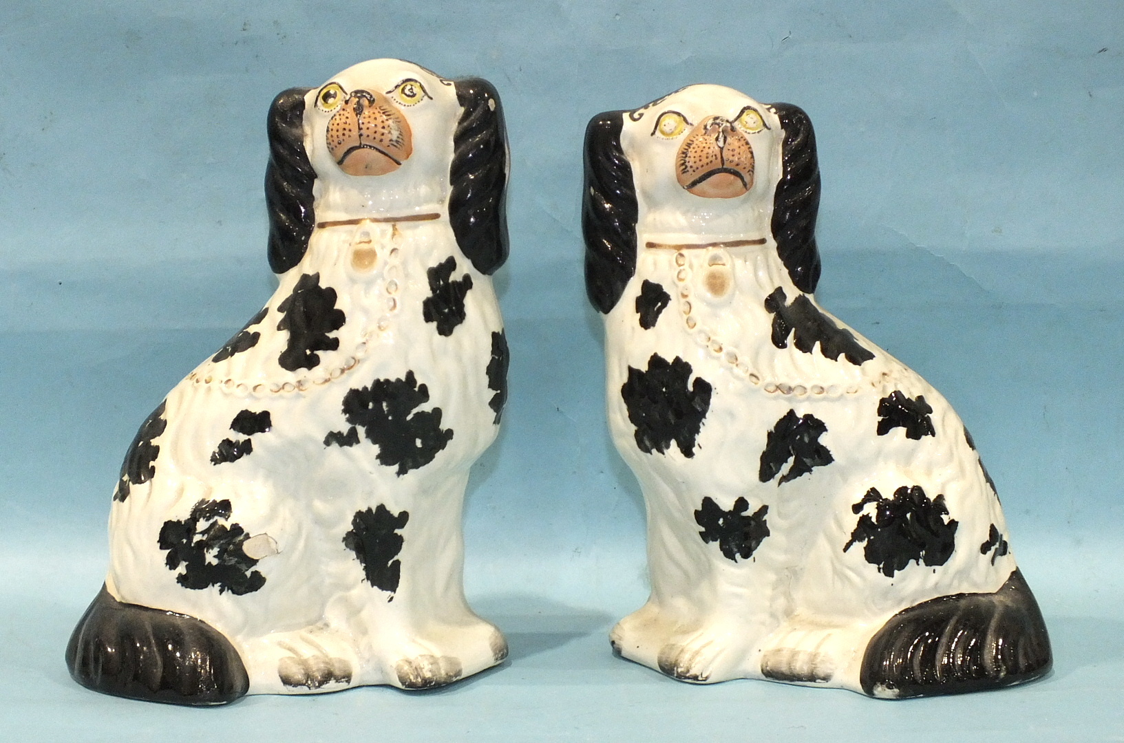 A pair of 19th century Staffordshire pottery spaniel figures with 'Disraeli curl' decoration, (one