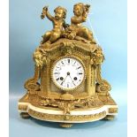 A 19th century French ormolu and alabaster mantel clock, the arched case surmounted by two