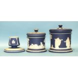 Two 19th century Adams jasperware jars and covers and a similar circular match strike, largest 14cm,