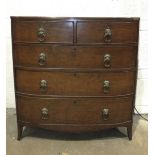 An early-19th century plum pudding mahogany chest of slightly-bowed form, with two short and three