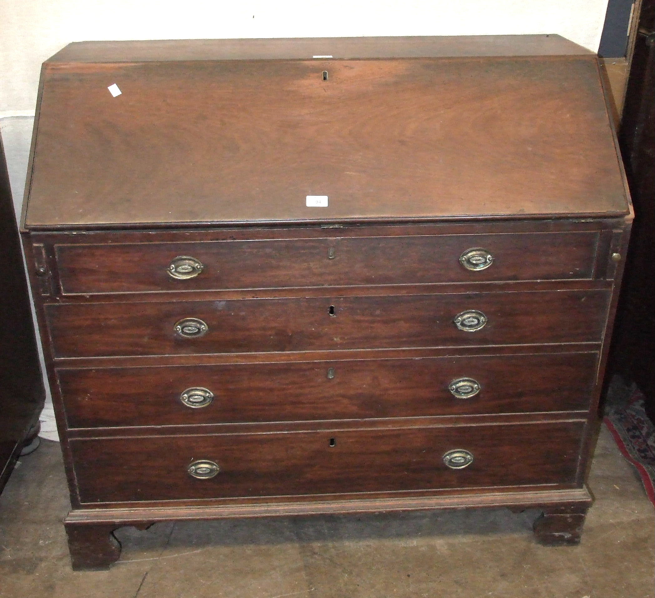 A George III mahogany bureau with fall front and fitted interior, above four cockbeaded drawers,