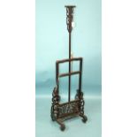 A late 19th/early 20th century Chinese hardwood extending lamp stand on end supports joined by a