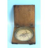 An 18th century nautical compass, the painted paper dial and brass outer ring within a decorated