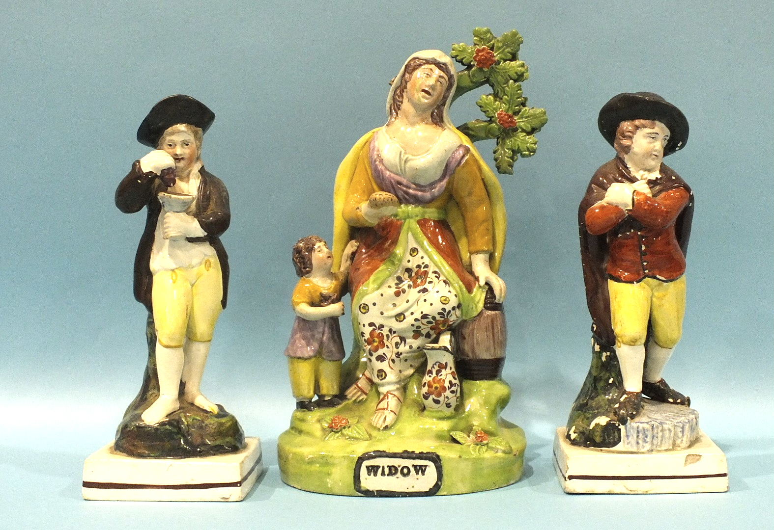 A 19th century Staffordshire bocage figure of a widow, 23cm high and two pearlware figures of Summer