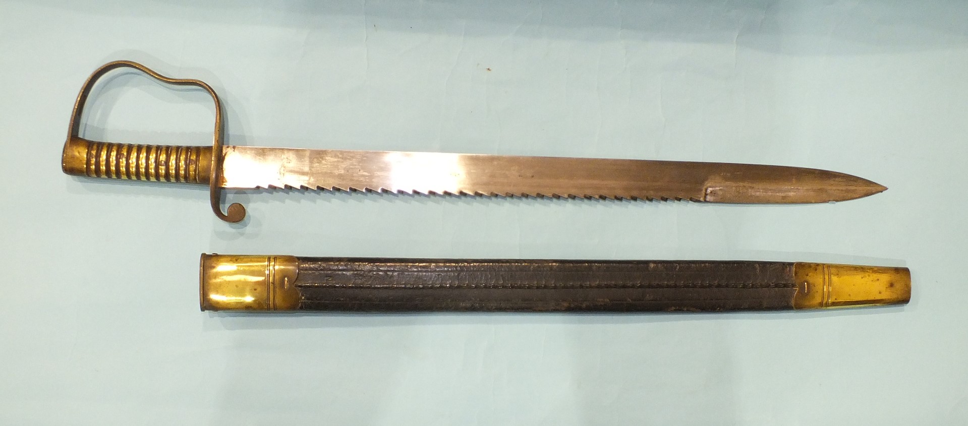 A British Pioneer sword with brass hilt and saw backed blade, 57cm, marked with crown over B21 and - Image 2 of 4