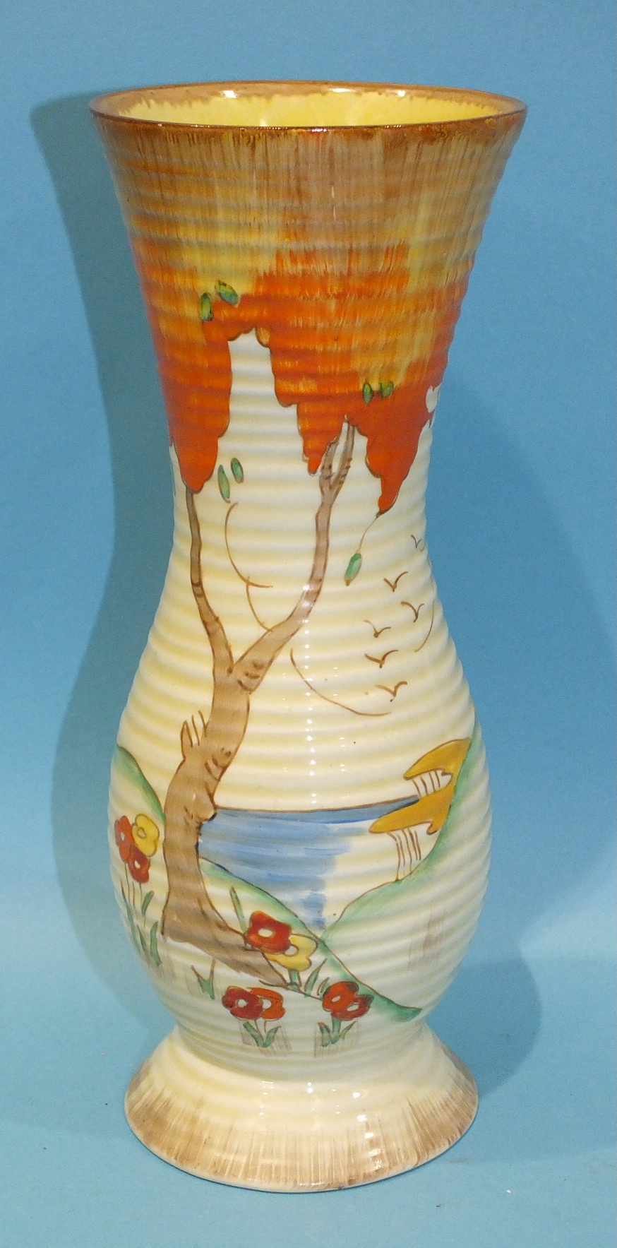 A Clarice Cliff ribbed vase, shape no. 719, decorated with the 'Taormina' pattern, (orange), printed
